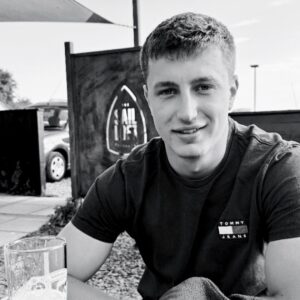 A young man smiling at the camera