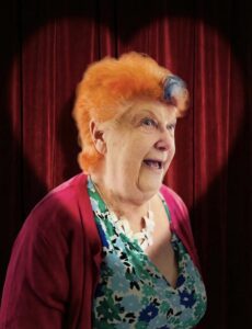 A picture of an older lady with orange hair